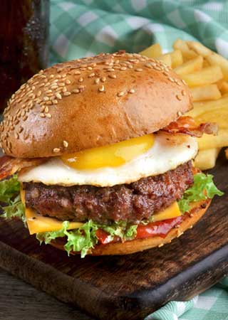 Photo of a gourmet cheeseburger meal.