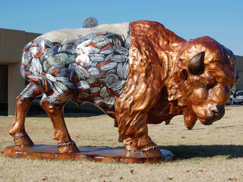 Painted buffalo sculpture with dollars and change