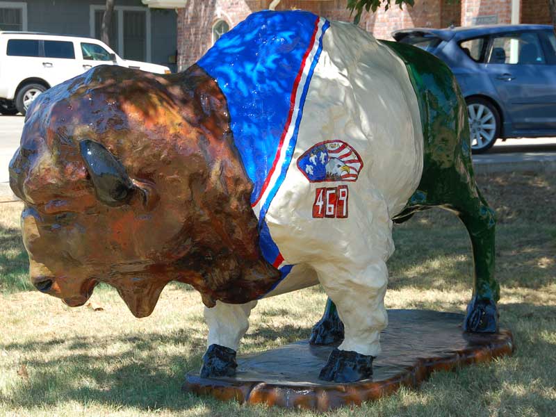 Painted buffalo sculpture with Boy Scout troop 469 uniform and patch. 