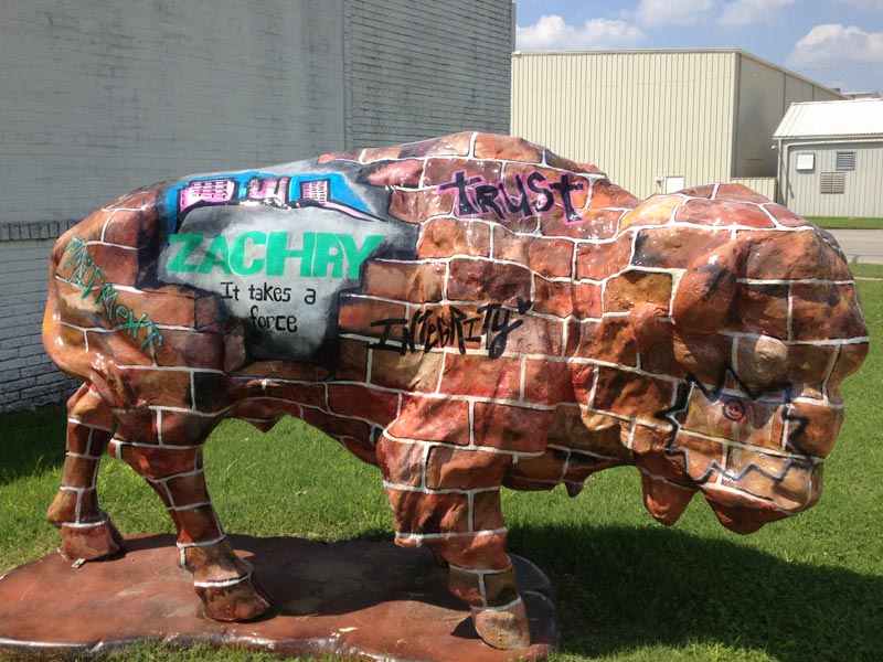 Painted buffalo sculpture with brick camouflage 