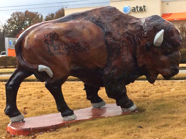 Painted buffalo sculpture with Pro Mortgage logo
